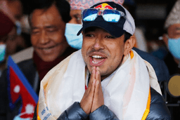 Nirmal Purja, one of the team member of the all-Nepalese mountaineering team that became the first to scale Mount K2 in winter, gestures as the team arrives at Tribhuwan International airport in Kathmandu, Nepal, Jan. 26, 2021. (AP Photo/Niranjan Shrestha, File)