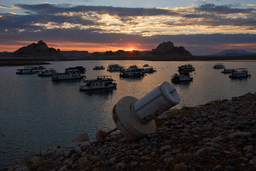 A formerly floating buoy now sits high and dry above Lake Powell at the Glen Canyon National Recreation Area, July 15, 2026, near Page, Nev. (AP Photo/John Locher, File)