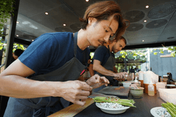 A chef prepares a new fish dish in fine-dining restaurant Noma's kitchen ahead of its new season in Copenhagen, Denmark Tuesday, July 28, 2026. (AP Photo/James Brooks)